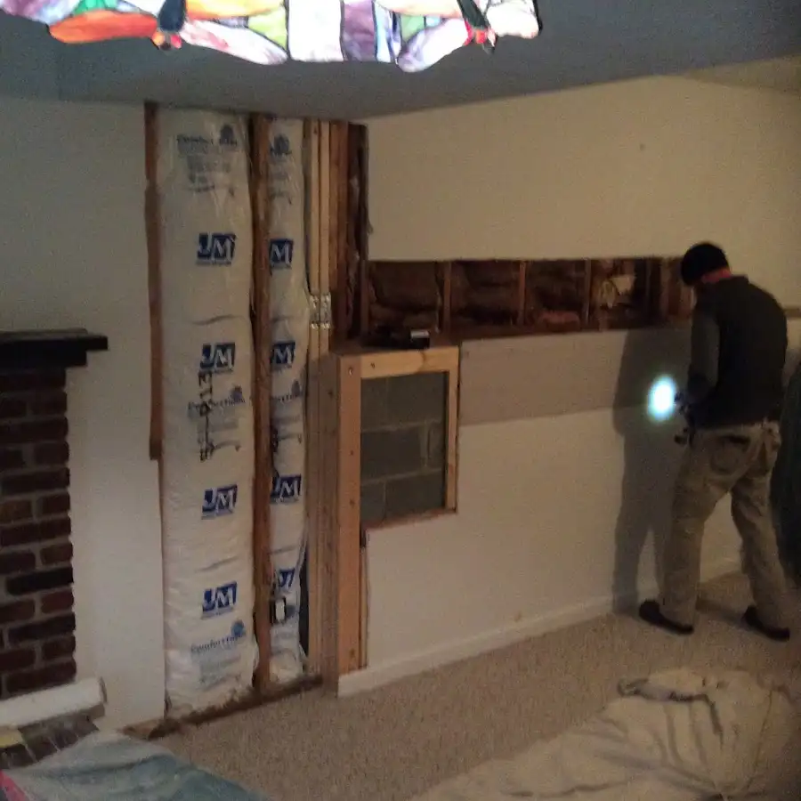 Restoration technician inspecting water damage in Aurora